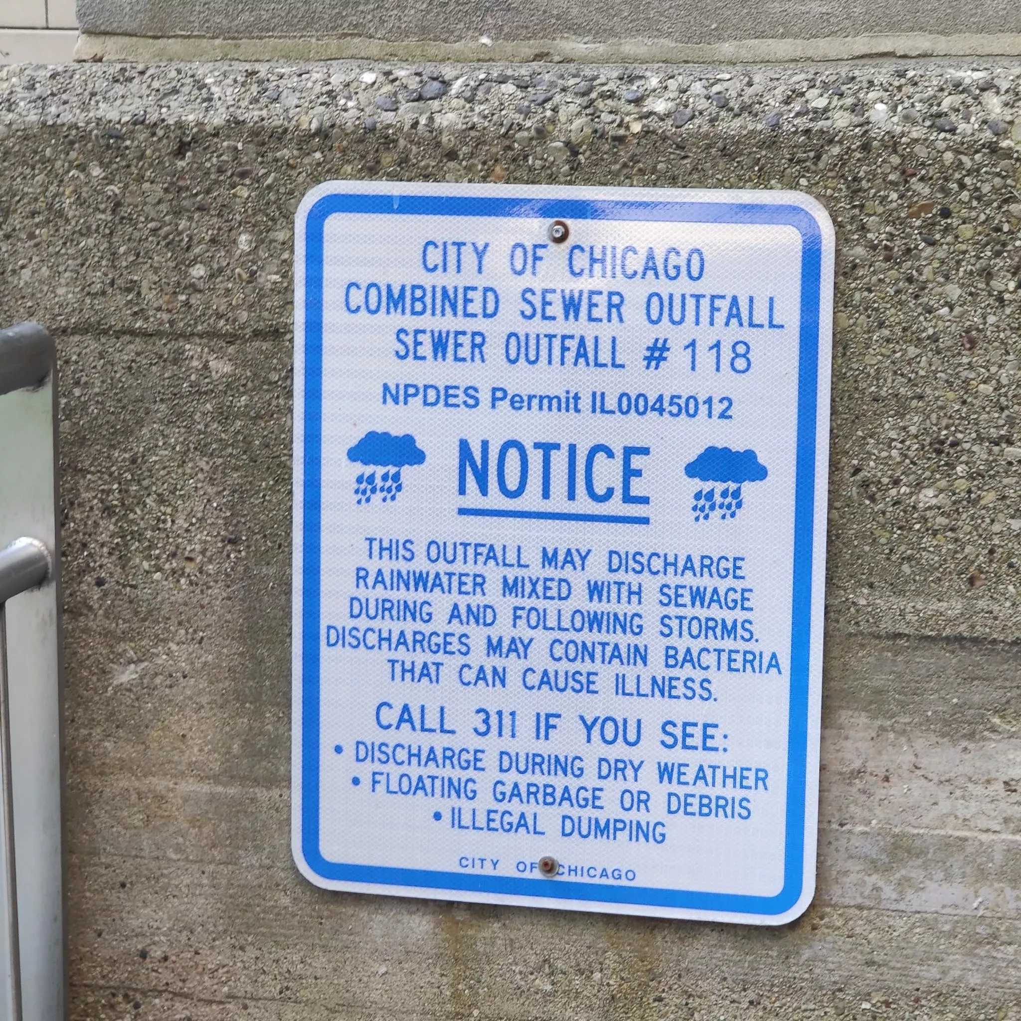 View of 
sewage warning sign along Mississippi River